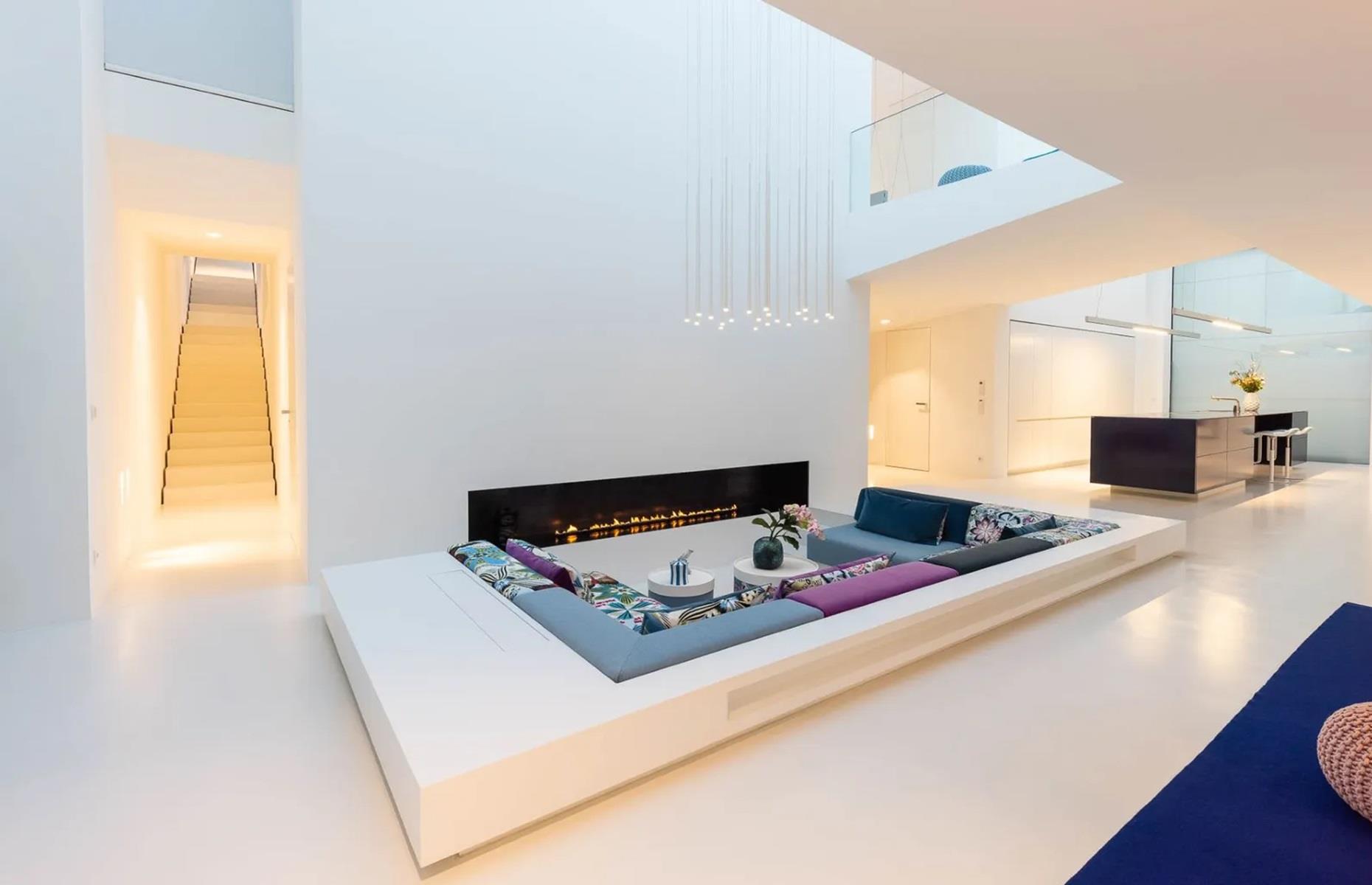<p>Inside, the property benefits from a sleek, all-white palette and an open floorplan with a sunken lounge, dining area and kitchen. The kitchen has a glazed ceiling, allowing the cook to take in the sky while they work their magic. Upstairs, a glass bridge connects the study with the library, home theatre and three bedrooms.  </p>