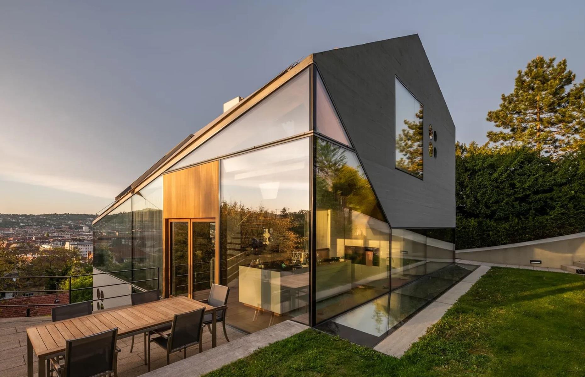 <p>Over in Stuttgart, Germany, you'll find this unusual <a href="https://www.loveproperty.com/gallerylist/68139/gorgeous-glass-houses-that-will-take-your-breath-away">glass home</a>. Built in 2014, the property sits on a slope and could certainly be described as a house of two halves. While the front is decorated in white render, the rear is covered in glass, allowing for amazing views across the city below.</p>