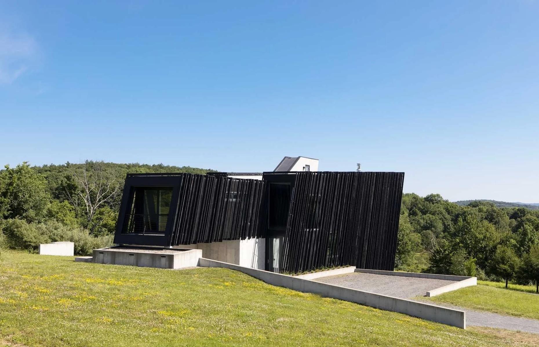 <p>Positioned on a 46-acre sloping plot, with dramatic views of the Catskills Mountains, the house was built to slot into its surroundings. According to <a href="https://www.realtor.com/news/unique-homes/sleeve-house-new-york-catskills-modern/">Realtor</a>, the architect said the idea was to create "two elongated volumes – a smaller one sleeved into a larger – sitting on a cast-in-place concrete base." Charred Accoya wood wraps the house like a skin. As well as looking amazing, the wood sleeve acts as a waterproof, insect-proof and fire-retardant cover, ensuring the exterior will stand the test of time. The wood is also resistant to rot and decay.</p>