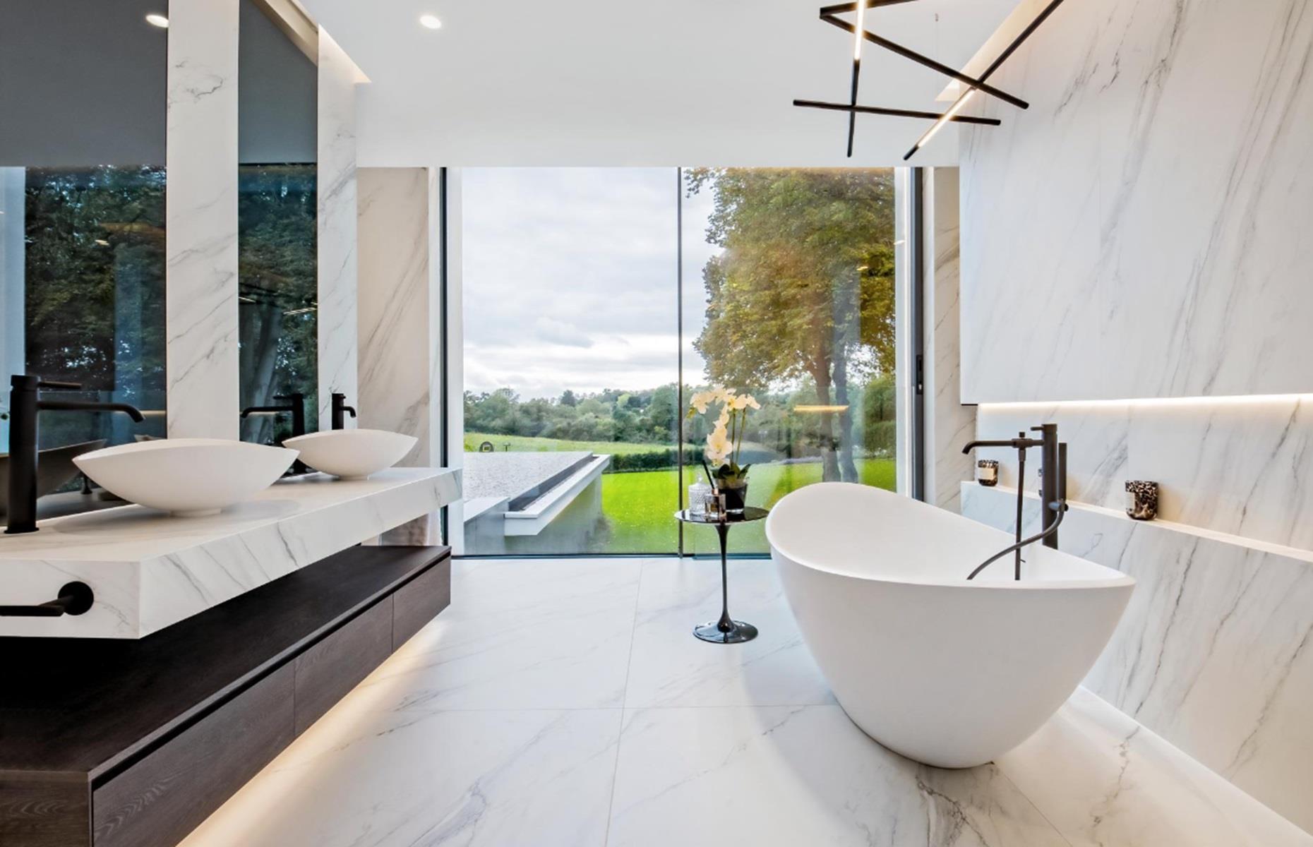<p>On the first floor, you’ll find the master suite – one of six bedrooms – which boasts a dressing room, an ensuite marble bathroom with a free-standing tub and a balcony overlooking the garden. As you might expect, the house also comes kitted out with Crestron Home Automation, <a href="https://www.loveproperty.com/gallerylist/69774/67-stylish-lighting-ideas-to-brighten-your-home">designer lighting</a>, automated blinds and a state-of-the-art security system.</p>