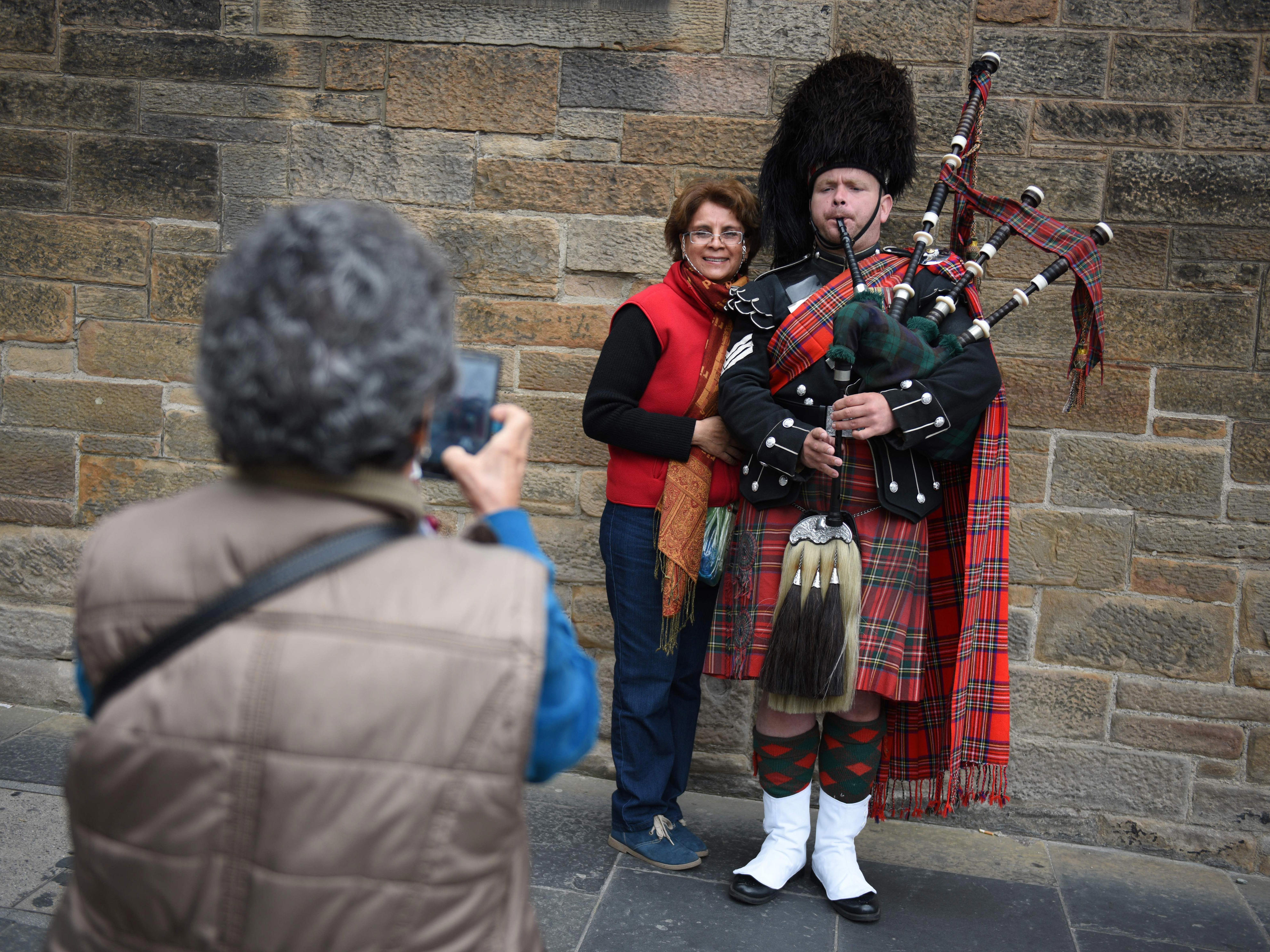 <p>Bagpipes are a traditional Scottish instrument that first became popular in the 14th century, according to the retailer <a href="https://www.kinnairdbagpipes.com/" rel="noopener">Kinnaird Bagpipes and Reeds</a>. They're most often played at formal events, including weddings and funerals, as well as remembrance events. </p><p>It's common to see street performers play the bagpipes in major cities, such as Glasgow, Edinburgh, and Inverness. Most locals will enjoy the music while continuing on with their day, but locals are easier to spot because they're more likely to stop and take a photo of the bagpiper. Some will even try to stop them for selfies.</p><p>While it's unlikely that the bagpiper would be annoyed by this, it's worth keeping in mind that you'll stand out in the crowd as a tourist if you gawk or take photos.</p>