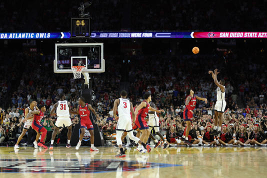 HOUSTON, TEXAS - APRIL 01: Lamont Butler #5 of the San Diego State Aztecs makes a basket as the clock expires to defeat the Florida Atlantic Owls 72-71 during the NCAA Men's Basketball Tournament Final Four semifinal game at NRG Stadium on April 01, 2023 in Houston, Texas. (Photo by Gregory Shamus/Getty Images) Gregory Shamus/Getty Images