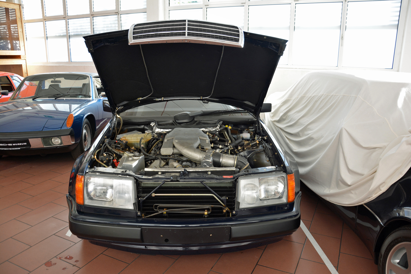 <p>Engineers tested the 989’s 4.2-liter V8 engine in real-world conditions by installing it under the hood of a <strong>Mercedes-Benz W124 E-Class</strong>. Period document note the W124 was chosen because it was close to the 989 in terms of size, weight, and performance. Never series-produced, the water-cooled V8 was also seriously considered as a replacement for the 911’s air-cooled flat-six.</p>