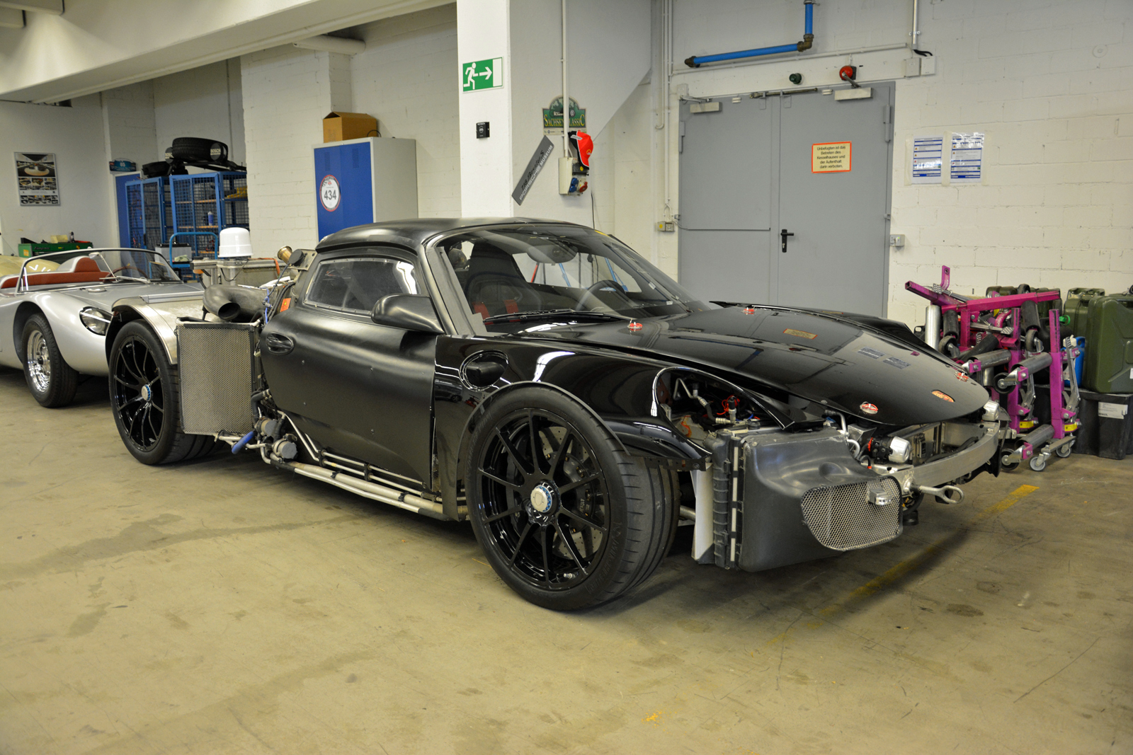 <p>No, this 918 Spyder wasn’t an extra in <strong><em>Mad Max</em></strong>. It’s a test mule cobbled together by taking near-production 918 components and installing them in a highly modified Carrera GT body. Retaining the stock headlights wasn’t possible, so the prototype-building department bolted small LED lights right below the hood.</p>