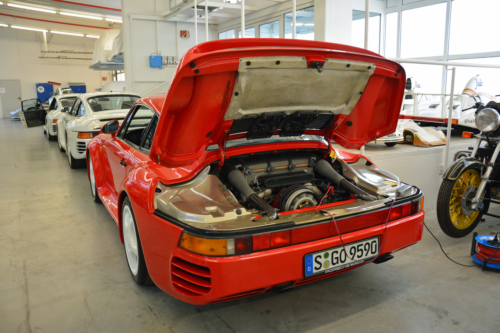 <p>Extensive use of lightweight materials such as Aramid and Nomex kept the 959’s weight in check. It was launched as a limited-edition model, and it sold out quickly in spite of an astronomical price of <strong>420,000 Deutschmarks</strong>. Porsche’s records indicate <strong>292</strong> cars were built; we saw at least four during our tour of the warehouse.</p>