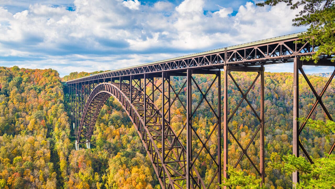 <p>Once simply a beautiful area with Class IV rapids, New River Gorge grows in popularity yearly. In 2020, the area was officially designated as a National Park, and for good reason. No matter what time of year you visit, you’ll find plenty of beautiful hiking, zipline, and, of course, whitewater rafting. </p><p>If you’re up for a challenge and want to see some stunning sights, head to the New River Gorge Bridge, a 3,000-foot-long architectural wonder that hosts an annual day where daring folks do free jumping. If you’re not that much of a daredevil, try out the bridge walk that offers a 24-inch wide platform underneath the roadway. Additionally, if you’re looking for places to eat, head to the local town of <a href="https://www.sandandorsnow.com/best-things-to-do-in-lansing-wv-in-fall/">Lansing, WV.</a> </p>