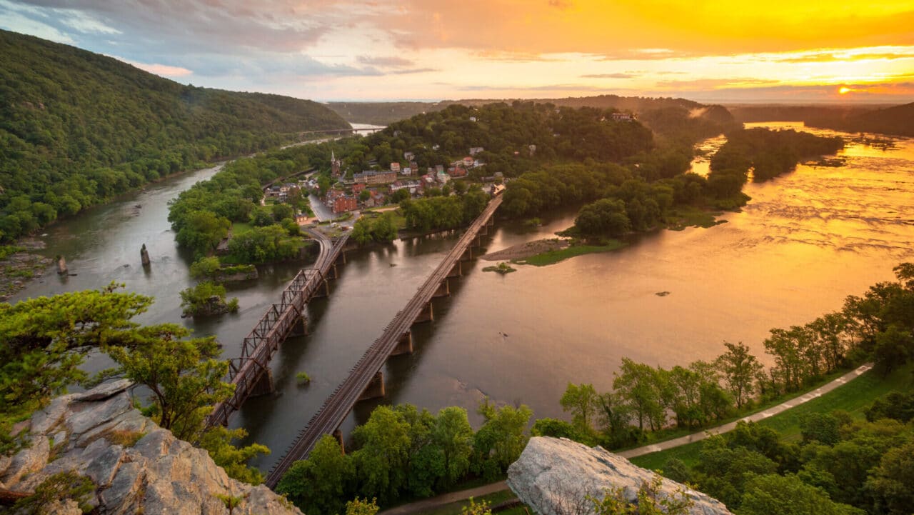 <p>In the heart of Appalachia, and at the confluence of the Potomac and Shenandoah Rivers, is Harpers Ferry, a quaint town filled with laidback charm. The lowest point in the state at 247 feet above sea level, it’s an ideal day trip. Famous for John Brown’s Raid against slavery in 1799, the downtown area is beautiful thanks to its 19th-century buildings and adorable streets. </p><p>Away from downtown, Harpers Ferry National Historic Park is very busy, especially during moderate temperatures. Remember there is an entrance fee, so take cash or credit card. Additionally, check out the Chesapeake & Ohio Canal National Historical Park towpath that’s part of the Potomac Heritage National Scenic Trail.</p>
