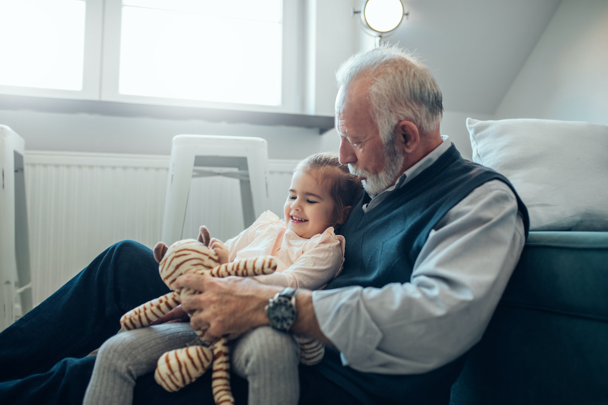 Her grandfather. Grandfather holding Apple and Orange.