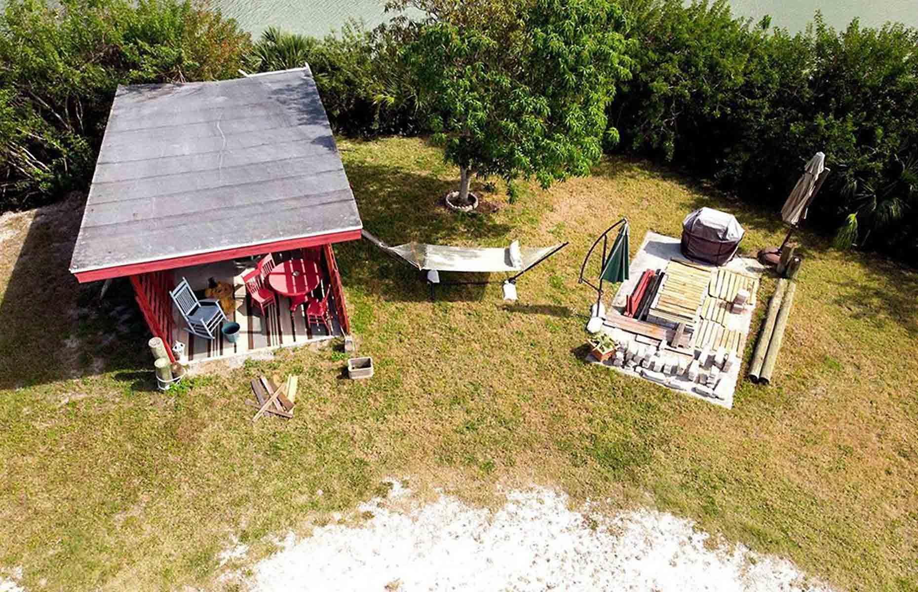 <p>When they purchased the property, Shellmate Island was home to a rundown storage shed and a dilapidated boat port. After completing their new tiny house and moving Tiffany to the island in June 2020, Tim and Sam decided it was time to give the rickety port a facelift.</p>  <p>“I figured out how to add structural support to it, sealed the roof, painted it, added a door and a couple of beams, added siding and mosquito nets", says Tim. Given a new lease of life, it's now a stylish outdoor living area for the couple and their friends and family <span>–</span> talk about a bargain backyard makeover!</p>
