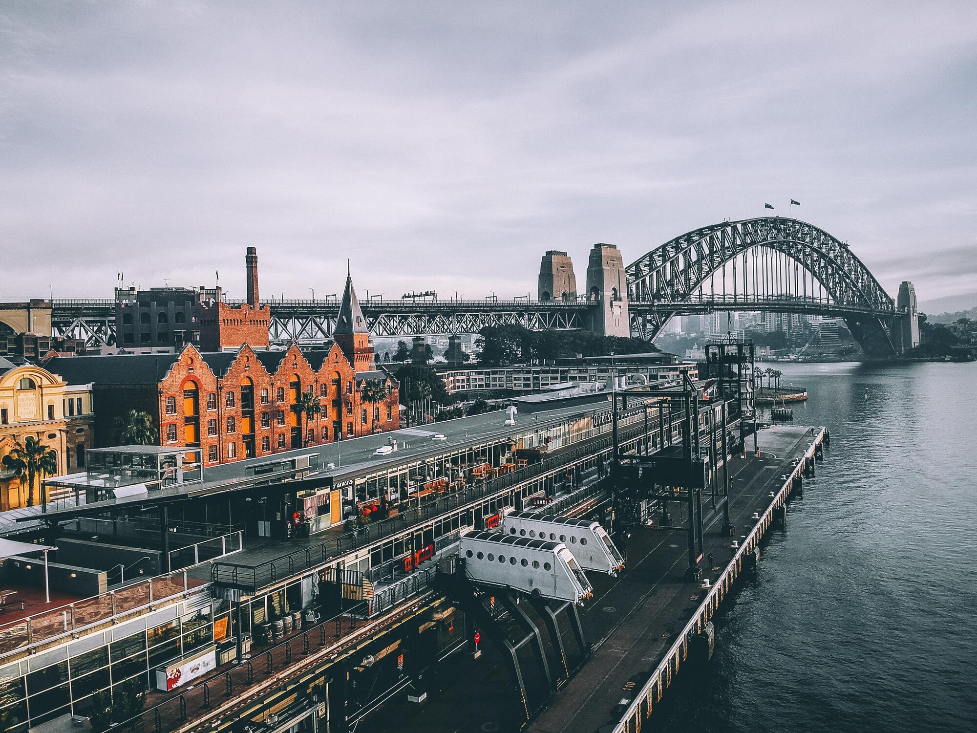 <p>Sydney Bridge passes over Sydney Harbour and is one of the city's most characteristic sites along with the Opera House. The bridge connects the financial area with the north coast of Sydney which is more commercial and residential. From the bridge, you can get incredible views of the whole city.</p> <p>Photo: Road Trip with Raj / Unsplash</p>