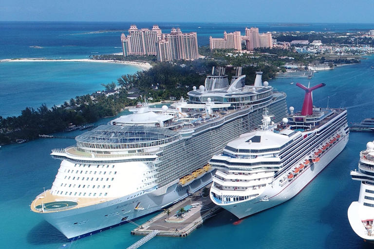 High Angle View Of Cruise Ships Moored In Sea Against Blue Sky