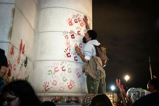 A demonstrator leaves a painted handprint on the wall of Union Station during a rally demanding a ceasefire for Palestine, on Nov. 17, 2023, in Washington, D.C.