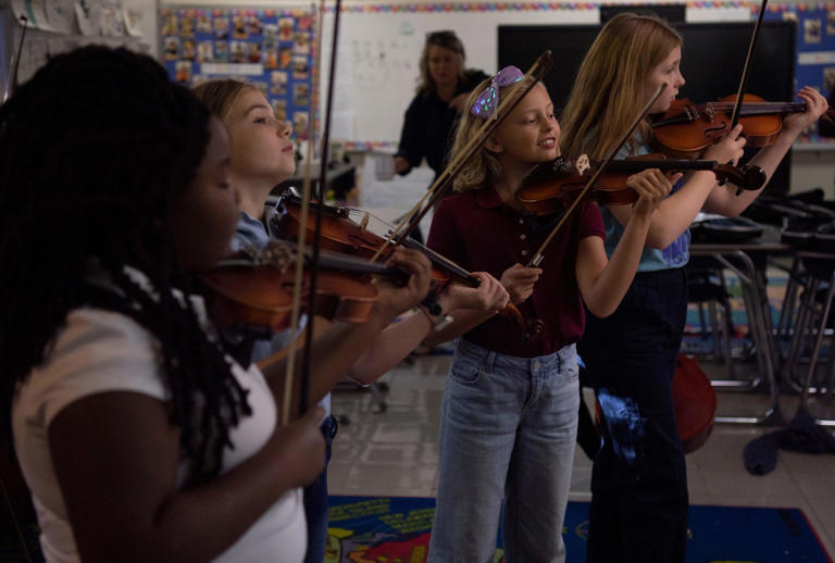 Layla Wilson, Sedona Ruskaup, Eleanor Welbourn and Everly Smith practice the violin during their strings class at Rosebank Elementary in Nashville, Tenn., Thursday, Nov. 2, 2023.