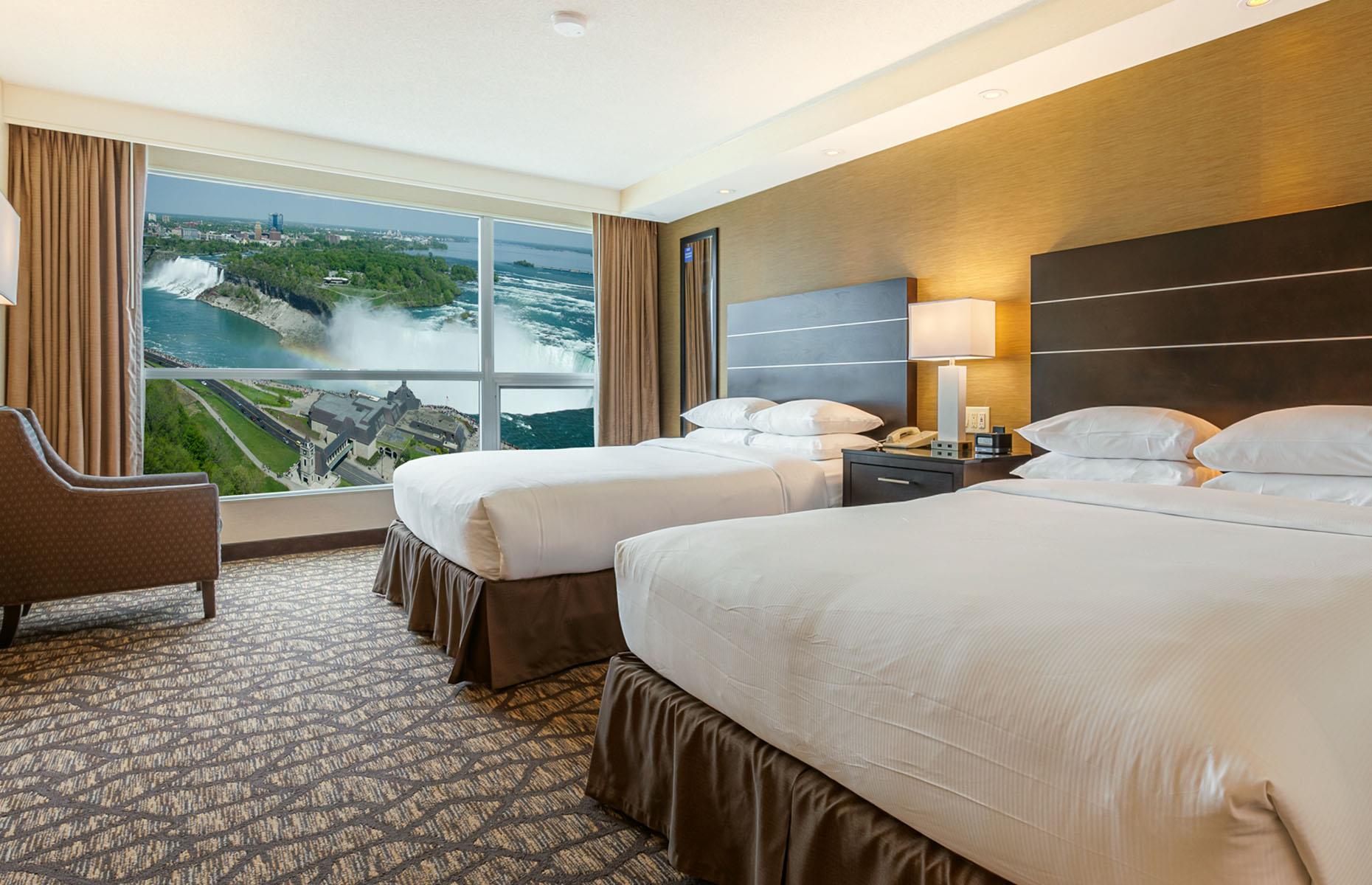 <p>For arguably the best views, stay at the 42-floor <a href="https://embassysuitesniagara.com/closest-hotel-to-niagara-falls.php?gad_source=1&gclid=CjwKCAiAu9yqBhBmEiwAHTx5pylShjgNTXqCwooLEMaR7jAvWbB6PmWr6u37O8eGWU3NIBKqE0qU6hoCzTgQAvD_BwE">Embassy Suites by Hilton</a>, located just 100 yards from the natural wonder. The high floor, two-room suites are super spacious, with two double beds, a living room area complete with sofa bed and flatscreen TV, bath and shower room, desk, fridge, coffee machine, microwave, wet bar, and the most incredible view you’ve probably ever experienced from a hotel room.</p>  <p>Breakfast is served with a view at the Keg Steakhouse and Bar, located on the ninth floor. Enjoy your eggs while you watch the sunrise over the falls. It’s spectacular.</p>