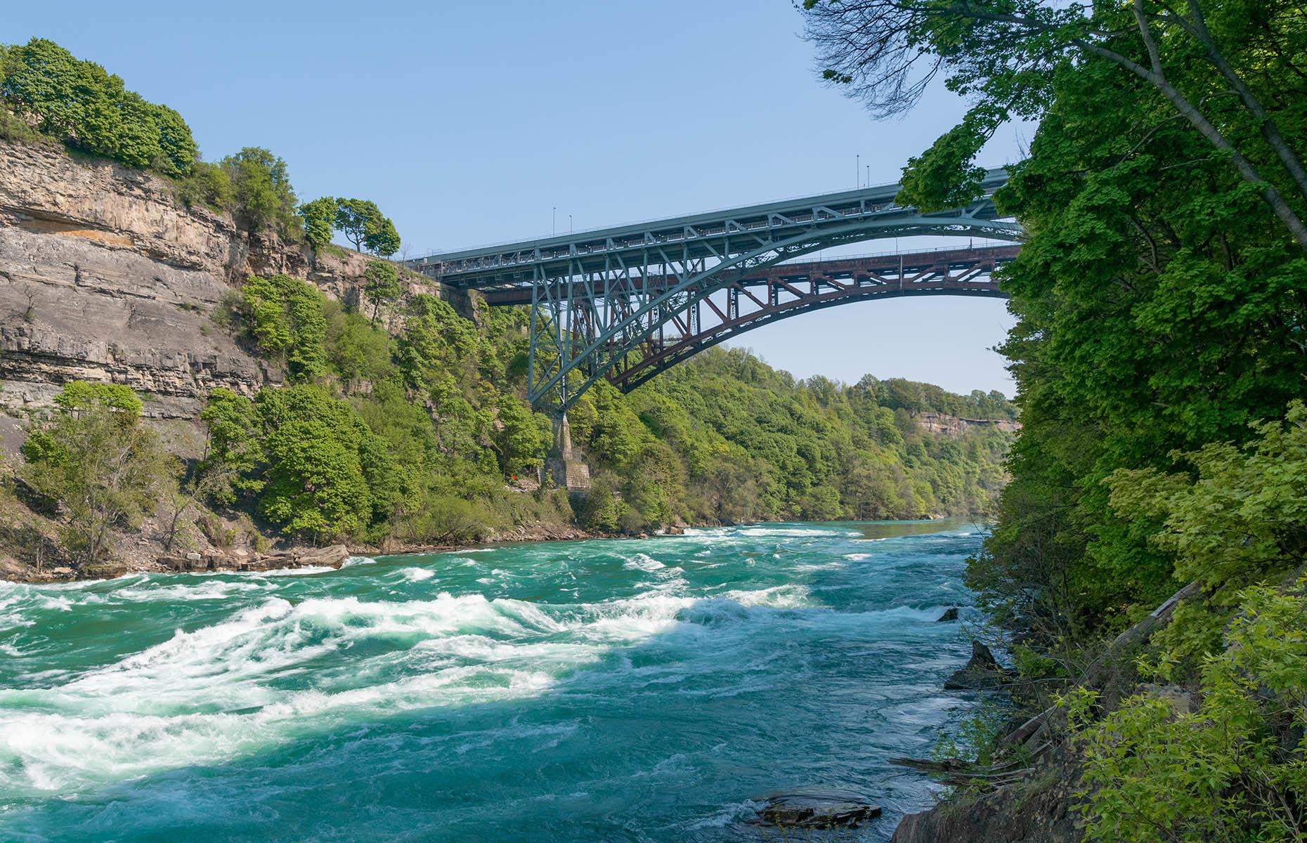 <p>Once you’re face-to-face with the Niagara River, take full advantage of the lookout points scattered throughout the quarter-mile boardwalk. When you get to the first platform, looking upriver, get your camera out. The Whirlpool Rapids Railroad Bridge will frame your shot perfectly.</p>  <p>The <a href="https://www.niagaraparks.com/visit/attractions/white-water-walk">self-guided tour</a> allows you to stop and read the stories and facts about the geology of the Great Gorge, as well as the plant and animal life surrounding it. Give the American tourists across the river a wave; you’ll spot a few doing a similar walk on the US side.</p>
