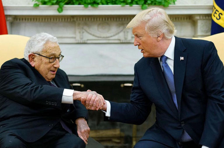 FILE - President Donald Trump shakes hands with former Secretary of State Henry Kissinger during their meeting in the Oval Office of the White House in Washington, DC, Oct.10, 2017.