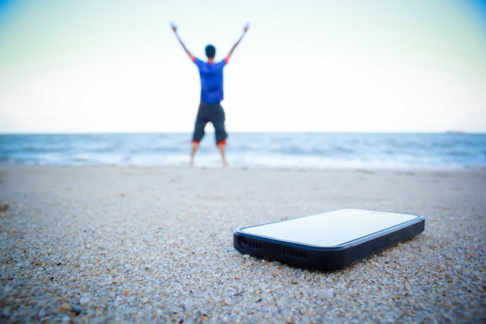 Daily travel. Man with Phone on Beach Sand Top view. Relax after stressful Day. Phone off.