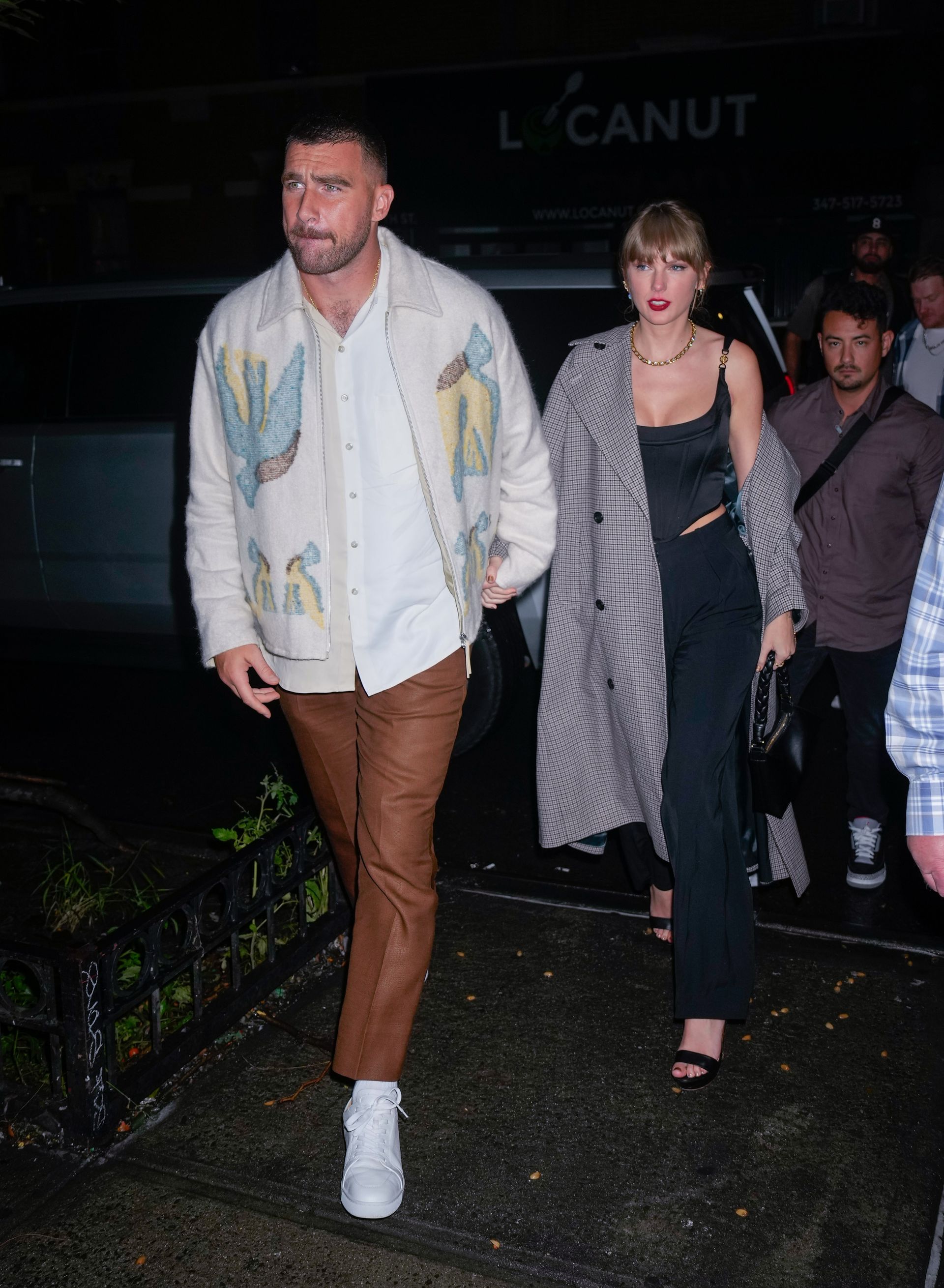 <p>                     Fans may have never been more excited than after hearing about Taylor Swift's relationship with Travis Kelce. Here, at the <em>SNL</em> afterparty, the two aren't exactly matching, per se, but still look great together (Swift is in a Versace corset top and gray plaid Gant trench coat, if you're curious).                    </p>