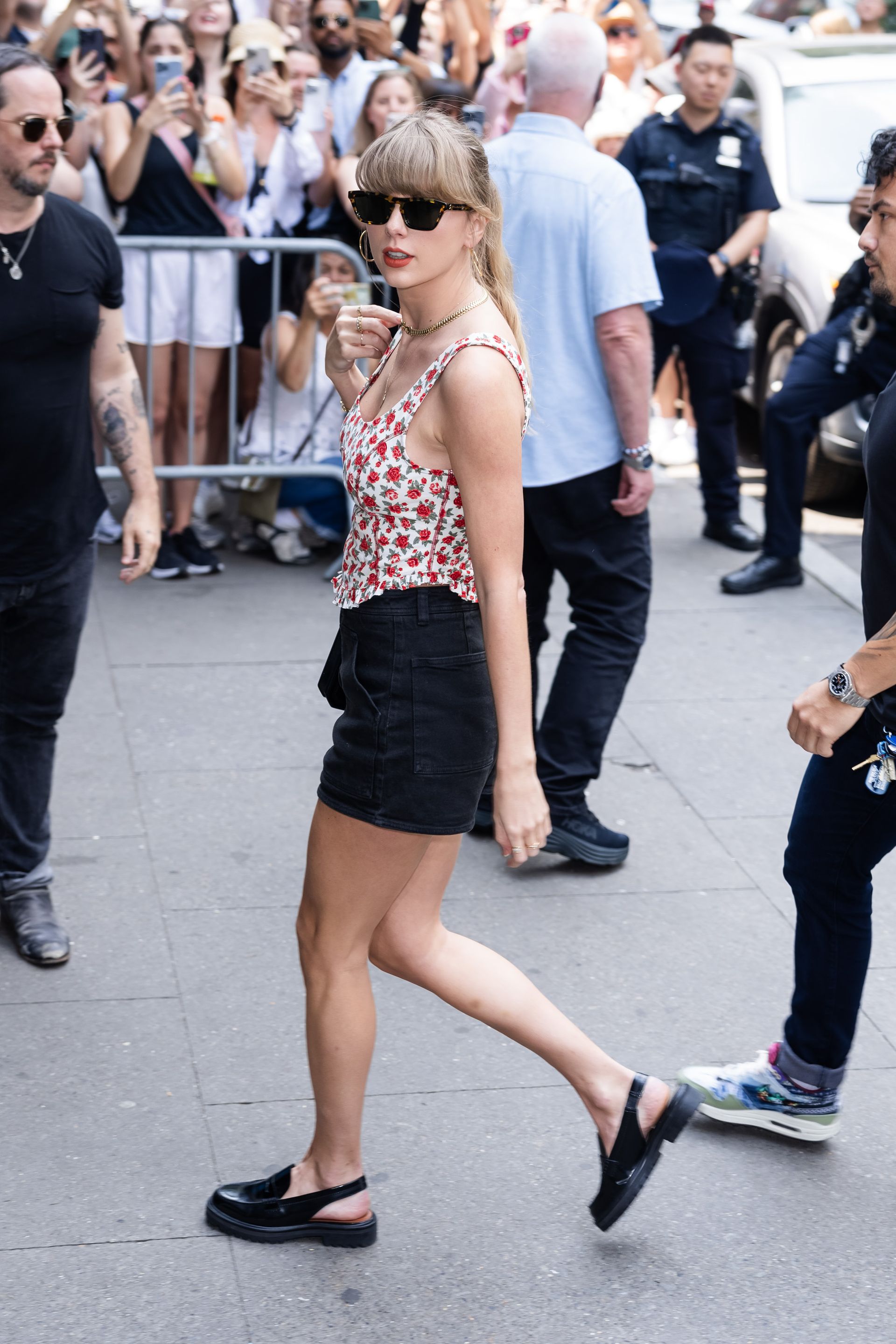 <p>                     The Taylor Swift of 2023 brought together trends and evolved her style in new and interesting ways. Take a floral red corset top, black denim shorts, chunky slingbacks, tortoise sunglasses, and a matching red lipstick, and you've got "Eras" Taylor Swift all the way.                   </p>