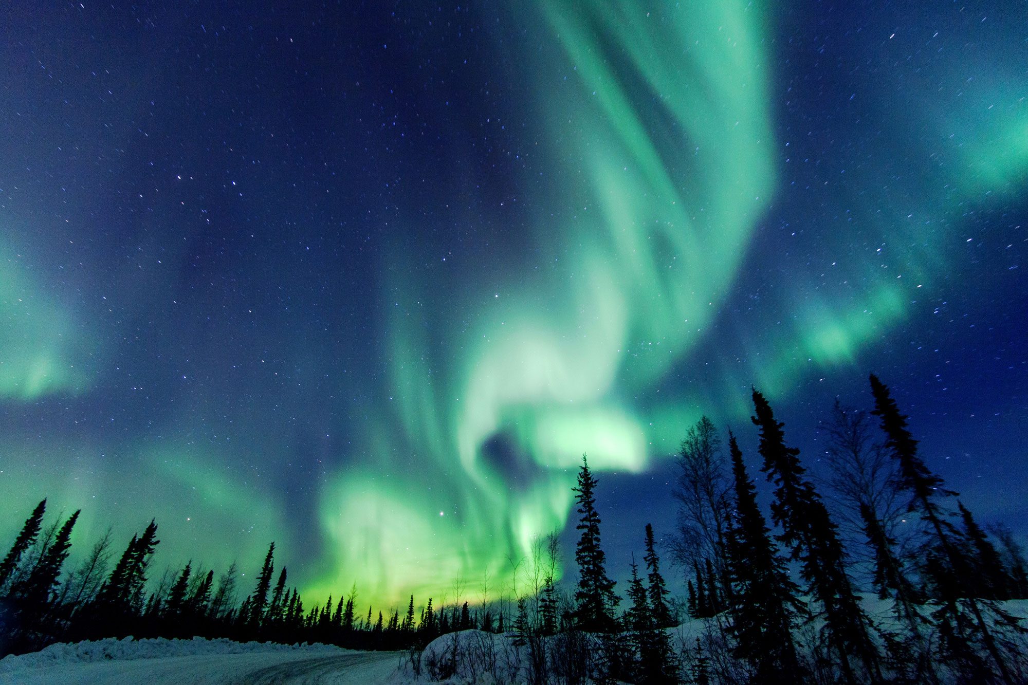 <p><strong>Why you should go:</strong> An almost-guaranteed opportunity to see the northern lights during the "solar max"</p> <p>There are two truths about seeing the <a href="https://www.rd.com/article/where-to-see-northern-lights/" rel="noopener noreferrer">northern lights</a>: They're beautiful, and they're elusive. Unlike the solar eclipse, there's no date or time that you're guaranteed to see the nighttime spectacular. You do need, however, to go north ... in winter ... and then wait. That's why we're so excited about the news from the Northern Territories of Canada, where a "solar max" cycle is going to make it possible to see the aurora borealis with new ease. According to the Canada Tourism Board, in the Northwest Territories, "travelers have a 98% chance of witnessing the spectacle" during a three-night stay November through March, when longer hours of darkness each day and clear nights make it easier to spot the lights.</p> <p>The jeweled green, purple and gold lights can be seen due to the perfect combination of clear nights, flat landscape, low humidity and the location beneath the earth's auroral oval. Even better, 2024 is the peak of the 11-year solar cycle, which means the light show will be even more dramatic than usual.</p> <p><strong>Where to stay:</strong> The main gateway to the area is Yellowknife, the location of <a href="https://www.tripadvisor.com/Attraction_Review-g154966-d586758-Reviews-Aurora_Village-Yellowknife_Northwest_Territories.html" rel="noopener noreferrer">Aurora Village</a>, an entirely Indigenous-owned experience that leads guided nighttime tours and where you can go dog sledding and snowshoeing. You can also spend the evening in a cozy teepee, complete with a wood stove, which makes it easy to pop out and see the aurora borealis when it lights up the sky.</p> <p class="listicle-page__cta-button-shop"><a class="shop-btn" href="https://www.tripadvisor.com/Attraction_Review-g154966-d586758-Reviews-Aurora_Village-Yellowknife_Northwest_Territories.html">Book Now</a></p>