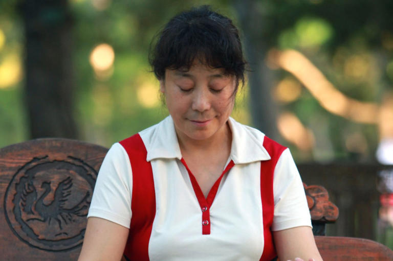 A woman meditates in a park in China where people have long incorporated mediation into their daily lives to balance the pressures of making a living and raising a family. Now, a major randomized, controlled European trial has shown the benefits to psychological well-being that meditation provides are real.
