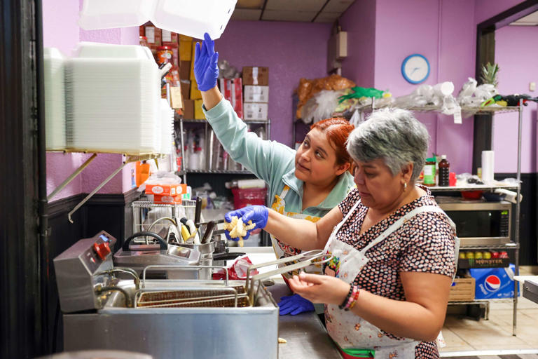 Johanna Rangel and her mother, Juana Arreguin, prepare food at their familys shop, Nevería El Sabor de México, in Pilsen on Oct. 12, 2023.