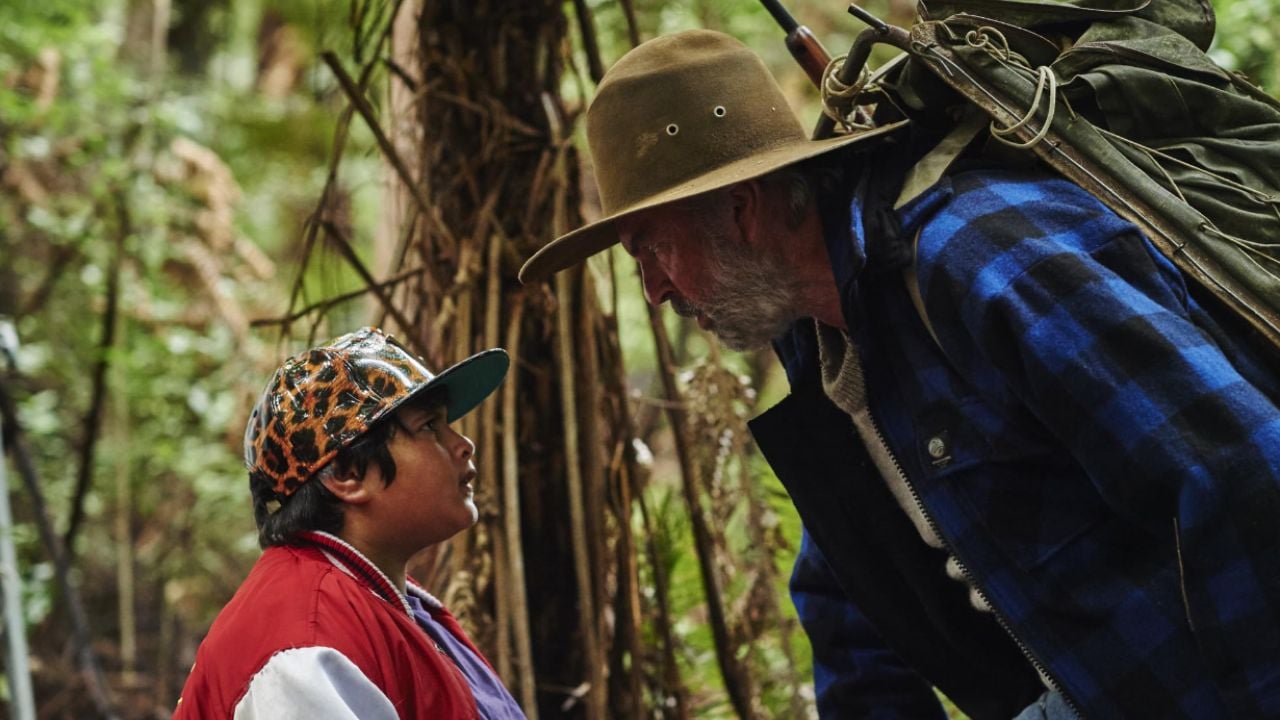 <p>Taika Waititi’s <em>Hunt For The Wilderpeople</em> acts as a road movie and a feel-good, coming-of-age comedy. Troubled teenager Ricky (Julian Dennison) is shipped around foster homes until he lands on Bella and Hec (Sam Neill).</p><p>When Ricky runs away from his home, Hec hunts him down, and the pair evade his officer, Paula (Rachel House), together. Waititi’s 2016 film never judges its leading characters and plays the realities of the situation straight. <em>Hunt For The Wilderpeople</em> skips past shmaltzy adoption feel-good movies to show a mutual understanding between a misunderstood teen and a curmudgeon father figure.</p>