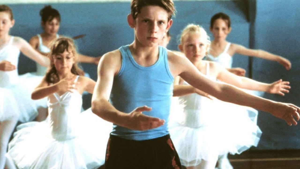 <p>Billy Elliot battles the stereotypes associated with masculinity and poverty to deliver the ultimate British feel-good movie. The movie tells the story of an 11-year-old from a Northern coal-mining town who wants to ballet dance, despite his father’s wishes.</p><p>The Stephen Daldry-directed film depicts Billy’s (Jamie Bell) newfound love for ballet, his own gender expectations, and his relationship with his dance teacher Mrs.Wilkinson (Julie Walters). This 2000 movie has the hallmark of all feel-good movies, showing a downtrodden protagonist achieving a dream they previously thought impossible.</p>