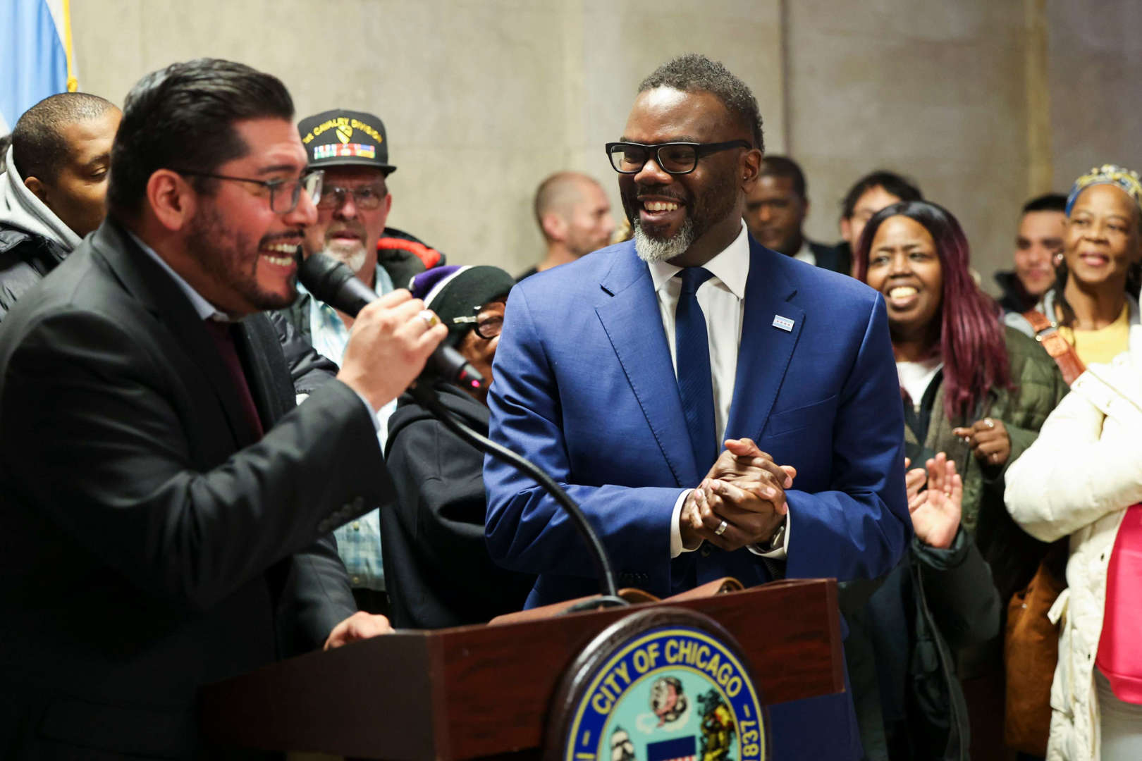 Ald. Carlos Ramirez-Rosa, 35th, left, celebrates with Mayor Brandon Johnson and members of the "Bring Chicago Home" coalition during a news conference after a Chicago City Council committee advanced an ordinance on Oct. 31, 2023.