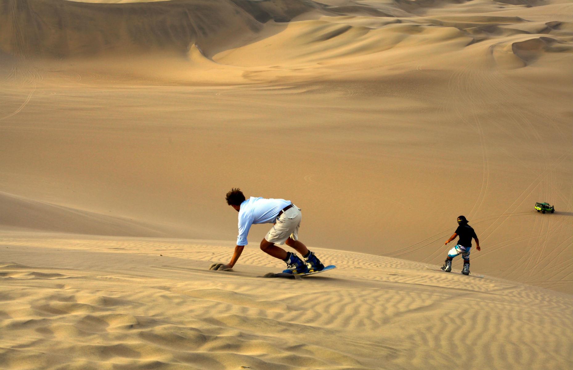 <p>Who needs snow when you have sand? The desert oasis of Huacachina in southwestern Peru is the perfect place to strap on a sandboard and put your skills to the test over the undulating sand dunes. If you’d rather sit in a vehicle, climb on board a dune buggy to take in the mesmerizing views without the adrenaline rush.</p>