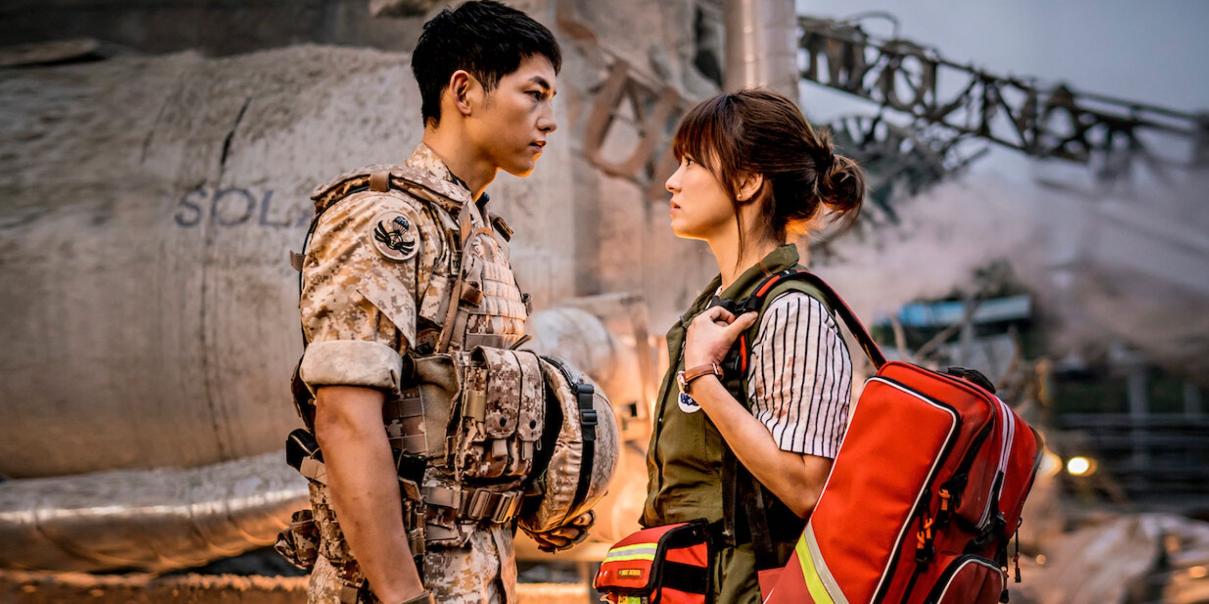 A soldier and a medic stand face to face in Descendants of the Sun