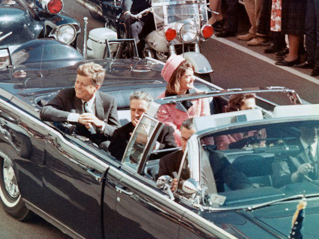 Bettmann US President John F Kennedy, First Lady Jacqueline Kennedy, Texas Governor John Connally, and others smile at the crowds lining their motorcade route in Dallas, Texas, on November 22, 1963.