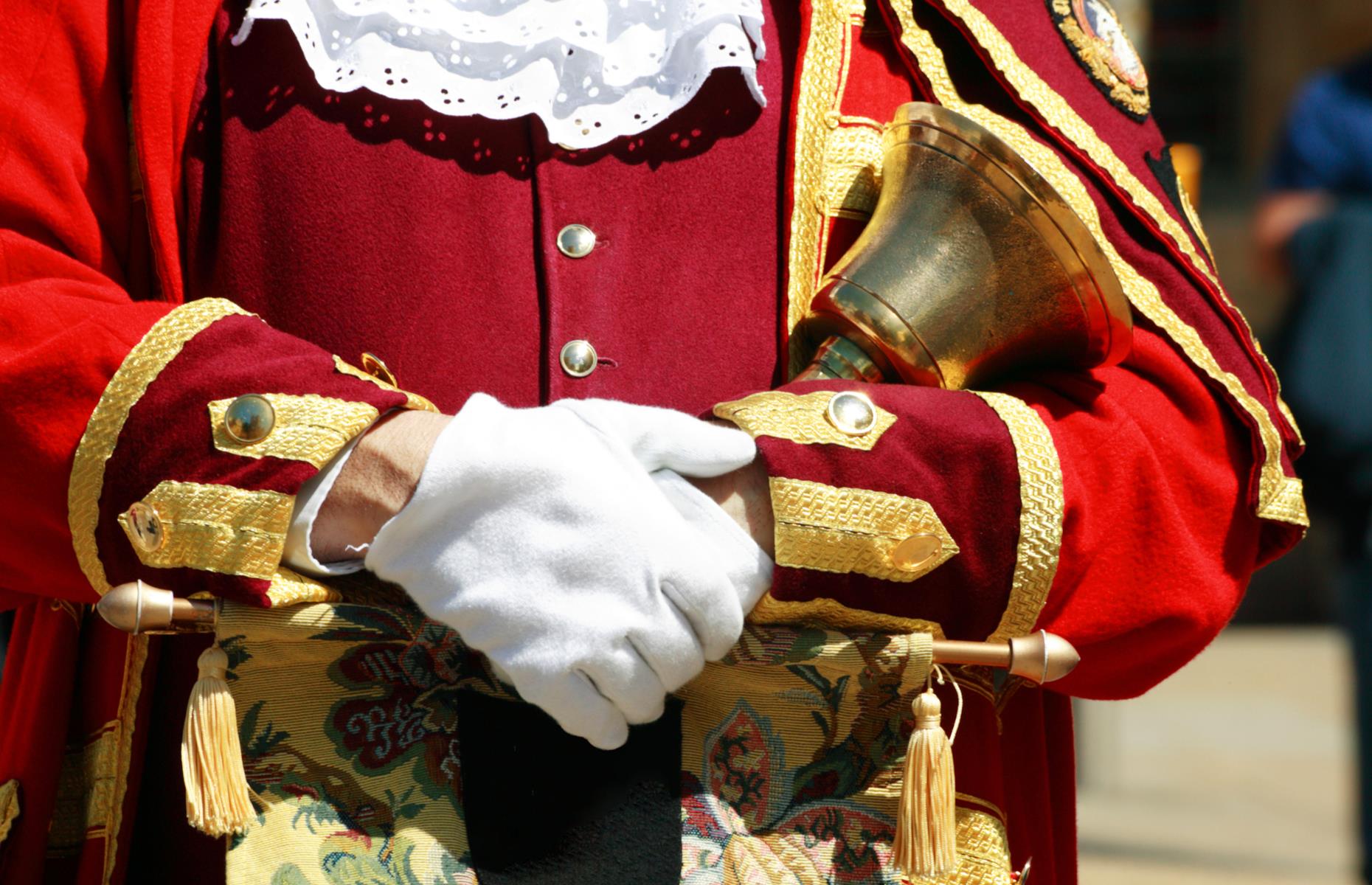 <p>Now few and far between, town criers, the most curious of British traditions, are unlikely to be spotted by incoming visitors. But if tourists do happen across these bellowing figures, they’ll be rightly dumbfounded.</p>  <p>Dressed in red and gold from head to toe, town criers would historically set about hollering the town news. Today, you’ll still occasionally come across them in quaint villages and remote little towns.</p>