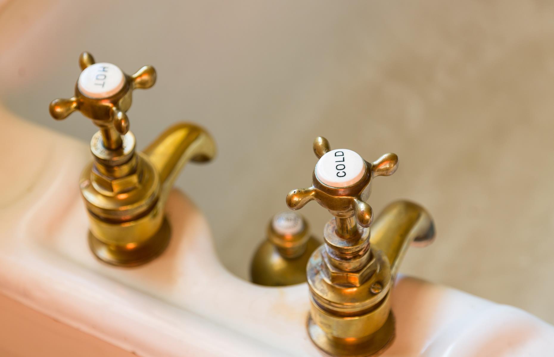 <p>Most countries have a singular faucet for their water but British bathrooms have separate taps for hot and cold. This concept dates back to after the Second World War when houses were built with a water storage tank in the attic – hot water is supplied by this tank while cold water comes straight from the mains.</p>  <p>It was presumed that the hot water source was more susceptible to contamination and deemed undrinkable. Thus, the ‘safe’ cold water is separated from the potentially risky warm supply.</p>