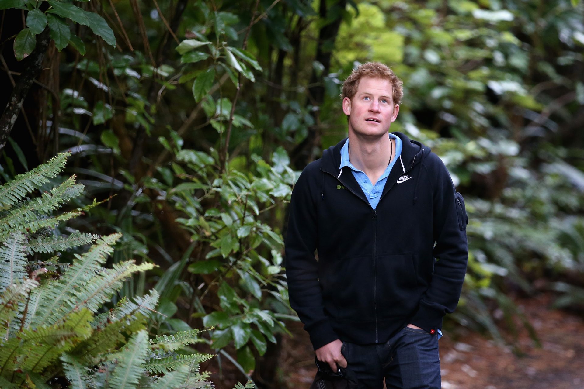 <p>That year, the prince visited New Zealand on his own. Here he's walking through a rainforest in the open wildlife sanctuary of Ulva Island</p>