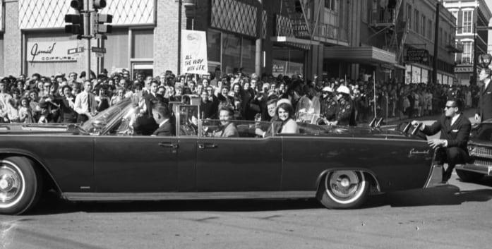 Clint Hill on the back of the limo on November 22, 1963.