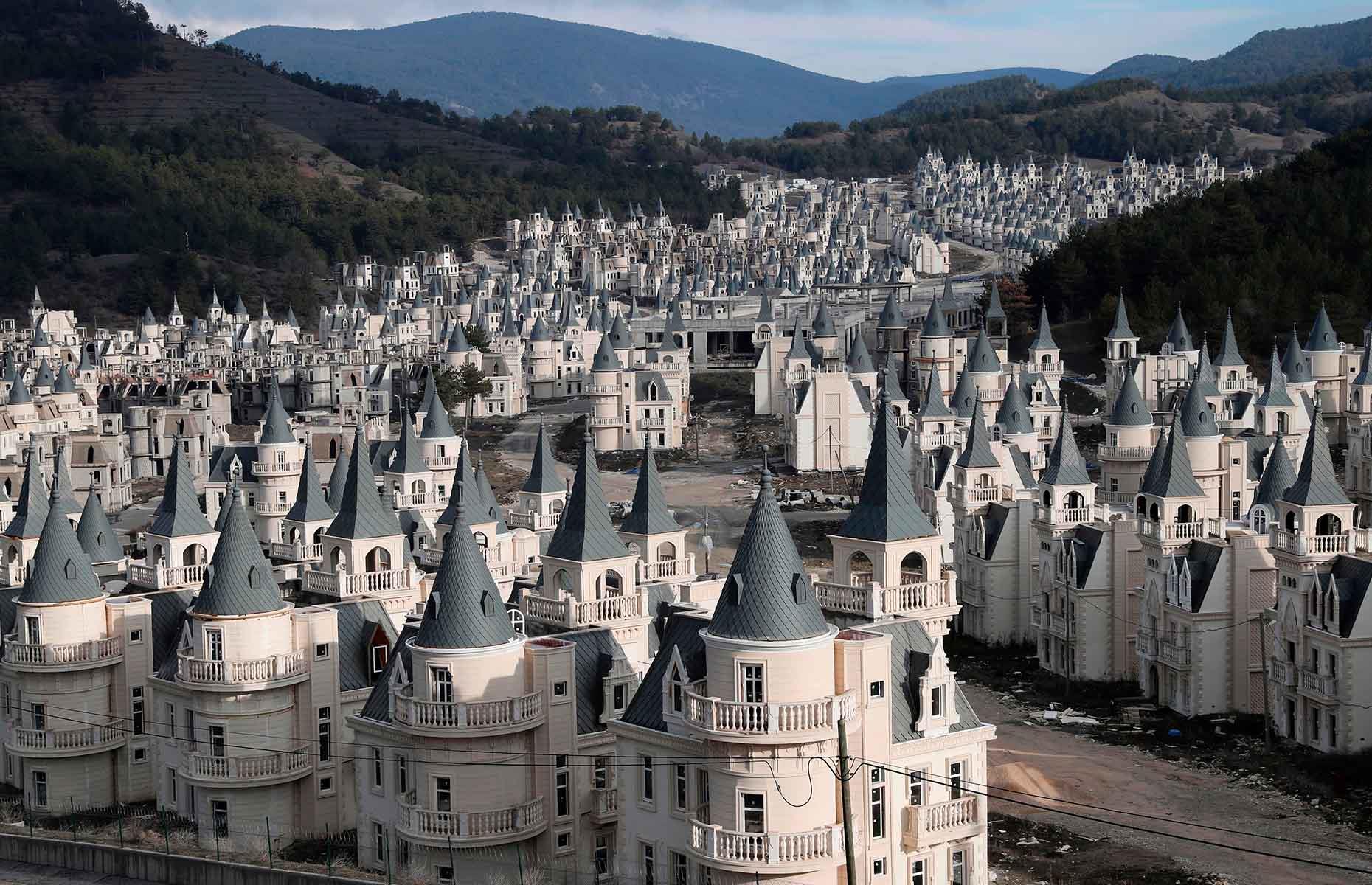 <p>Nestled in a rural mountainous spot, halfway between Istanbul and Ankara, this modern abandoned ghost town is a surreal sight to behold. Hundreds of mini châteaux, in various stages of completion, stand in a deathly silent valley after funding for the project dried up.</p>