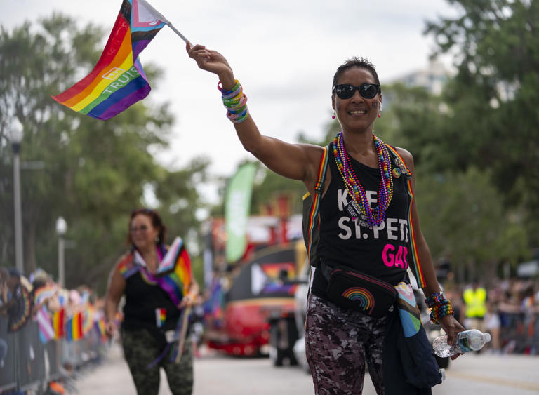 A participant waves a Pride flag during the St. Pete Pride Parade along Bayshore Drive.