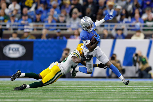 Green Bay Packers cornerback Corey Ballentine tackles Jameson Williams during the first quarter of the Thanksgiving Day game on Nov. 23 at Ford Field.