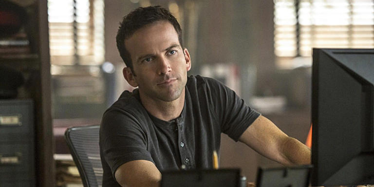 Lucas Black as Christopher LaSalle sitting in front of a computer on NCIS: New Orleans