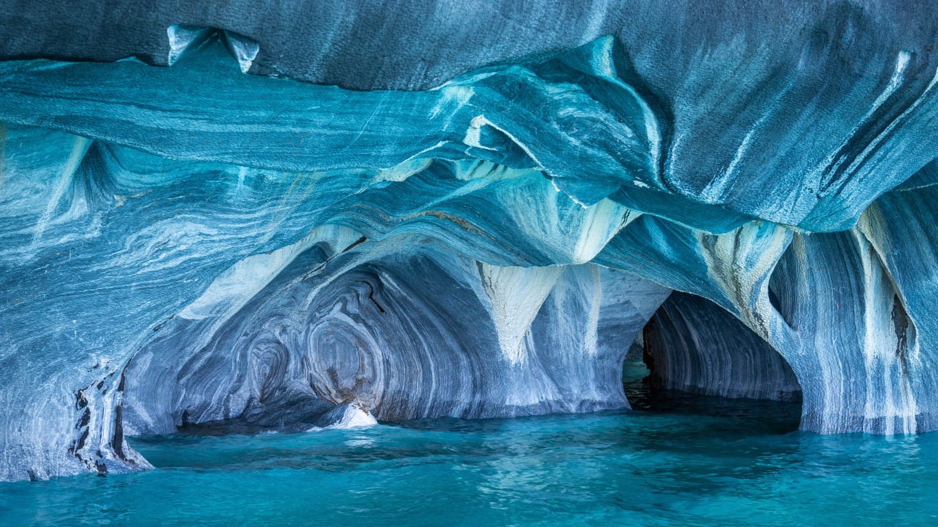 <p><strong>> Location: </strong>Chile</p> <p>The only way to reach the Marble Cathedral is by traversing the glacial lake of General Carrera by boat, or for those seeking a bit more adventure, using a kayak. General Carrera Lake and the marble cathedral are located in Chilean Patagonia, on a peninsula of solid marble. The brilliant blue-striped caverns are the result of 6,000 years of erosion caused by waves lapping against the marble.</p>