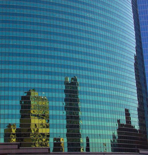 buildings reflecting in the window of another building