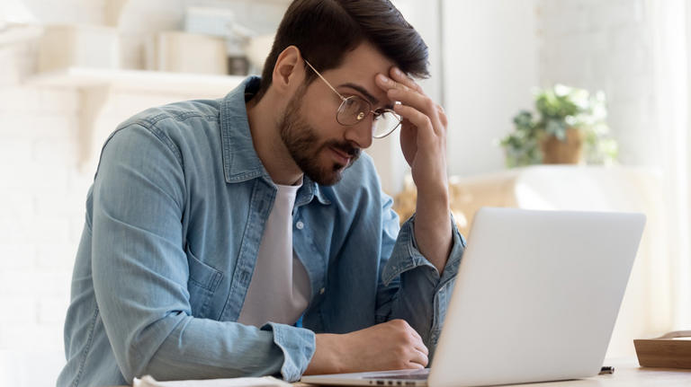 Individual staring at laptop screen