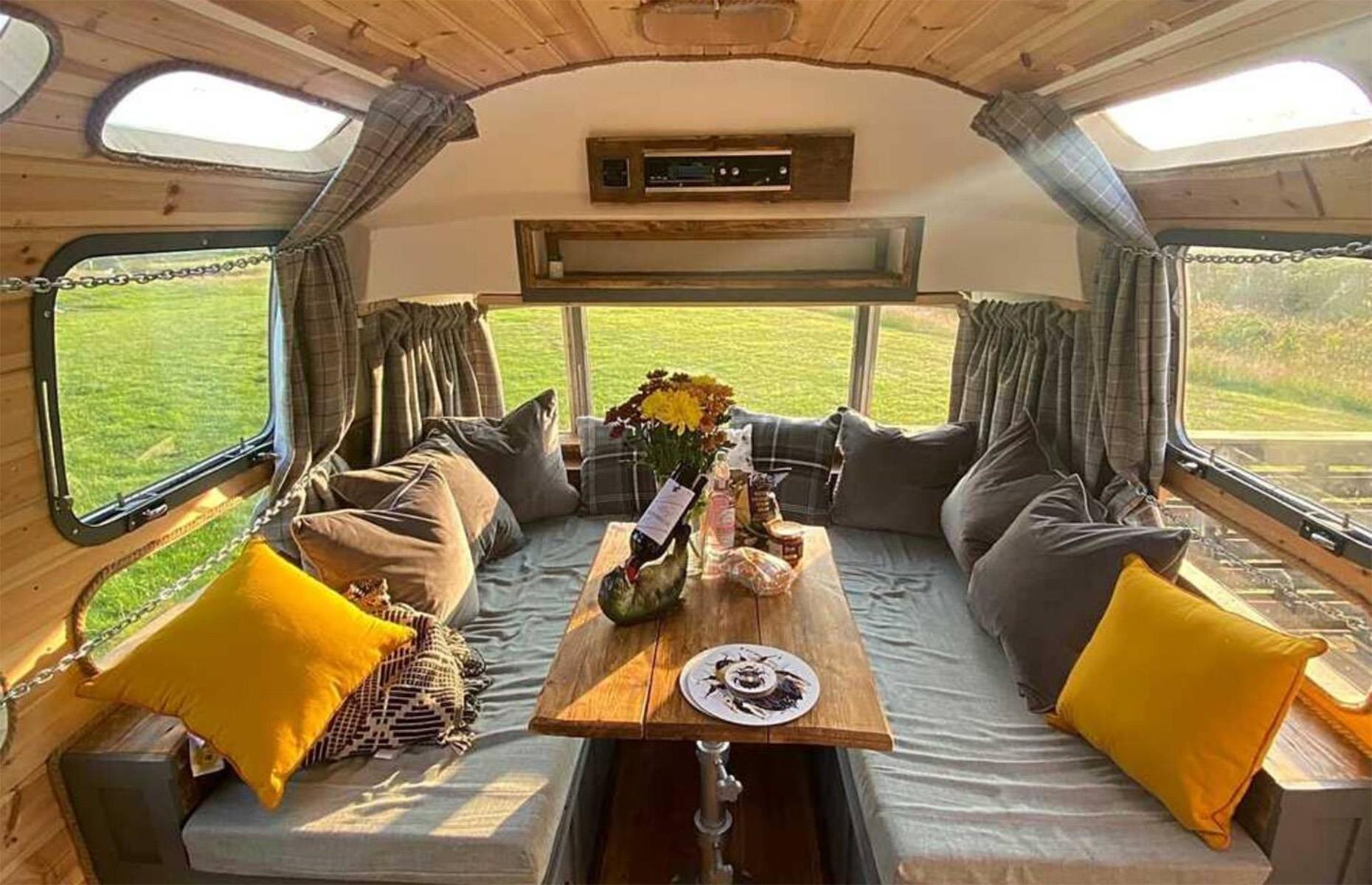 <p>The Airstream includes a fully equipped kitchen, bathroom, bedroom and dining area, which also converts seamlessly into another bed if required.</p>  <p>The interiors are finished to a high standard, with cozy soft furnishings which complement the light wood paneling that runs throughout the space.</p>