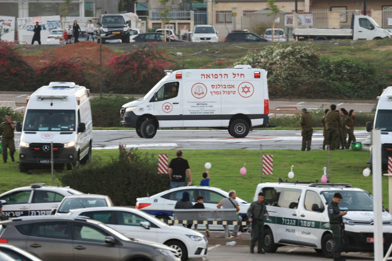 Israeli security forces stand next to ambulances on standby outside the helipad of Tel Aviv's Schneider Medical Centre on Nov. 24, 2023, amid preparations for the release of Israeli hostages held by Hamas.
