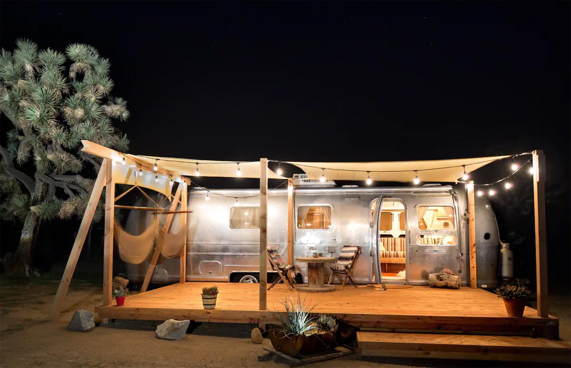 <p>Unlike some of the more modernized trailer projects we’ve seen, this fabulous 1975 Airstream truly embraces its origins with a renovation that's faithful to its playful heyday.</p>  <p>Alongside that beautifully restored exterior, there's a large wooden deck adorned with shade sails, fairy lights and two hammocks – perfect for a cozy evening of stargazing.</p>