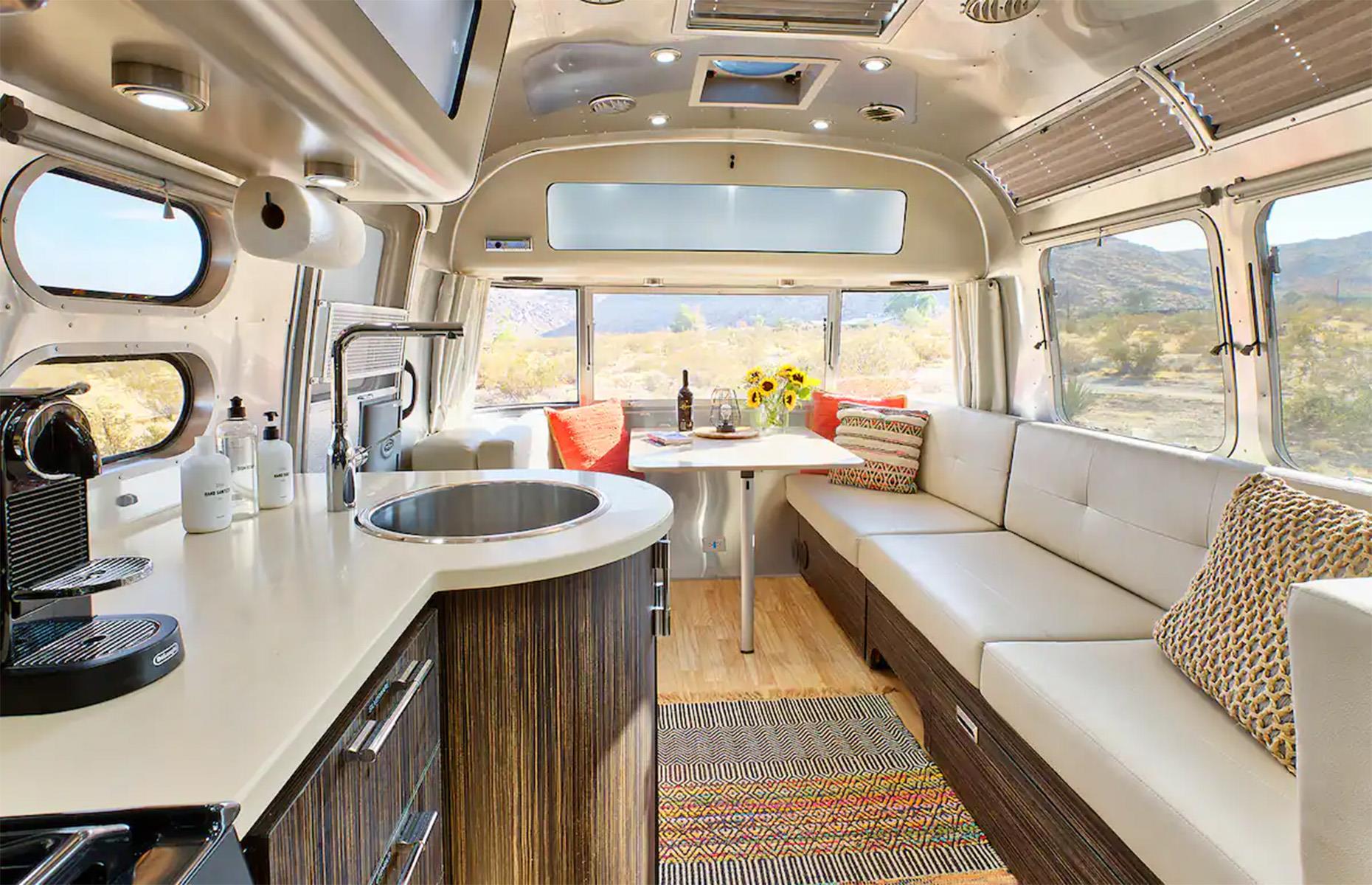 <p>In addition to a queen-size bed at the rear, the couch converts easily into a secondary single bed, allowing the Airstream to comfortably sleep up to three people.</p>  <p>There’s also more than enough room to spread out outside, with two spacious wooden decks, an outdoor fireplace, a Jacuzzi, a cowboy tub, an outdoor shower and a built-in barbecue area fully equipped with a propane grill, side burner and sink. Imagine dining alfresco against that stunning desert mountain backdrop!</p>
