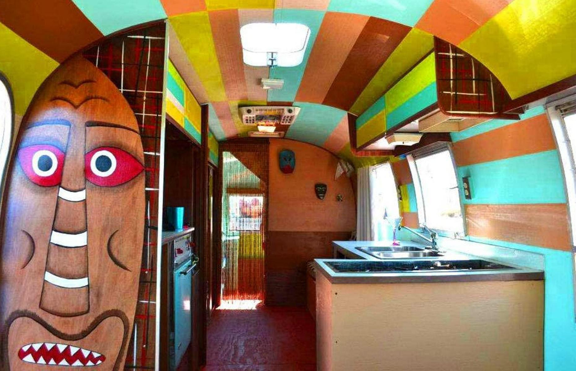 <p>The characterful design inside is full of colour and quirky tiki-themed accessories designed to get you in the holiday mood.</p>  <p>We love the bold, colour-blocked ceiling and walls, which draw the eye further down the trailer and impart plenty of personality to the snug space.</p>