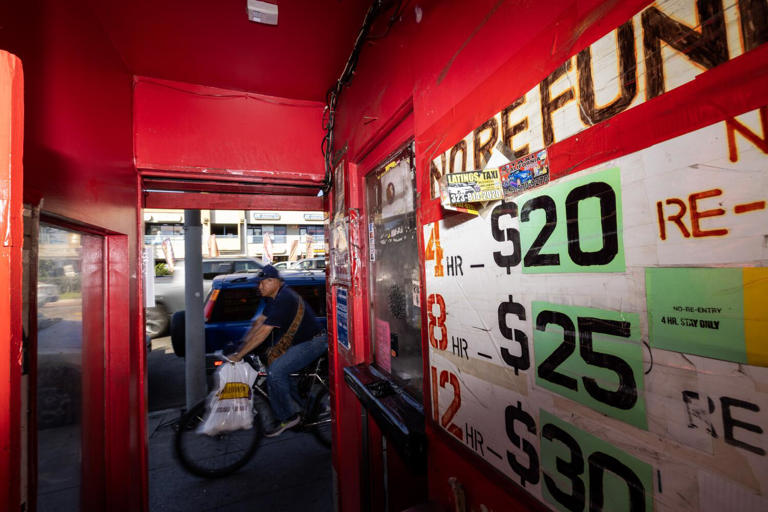 A cyclist rides past the entrance to the Tiki Theater on Santa Monica Boulevard. ((Brian van der Brug / Los Angeles Times))
