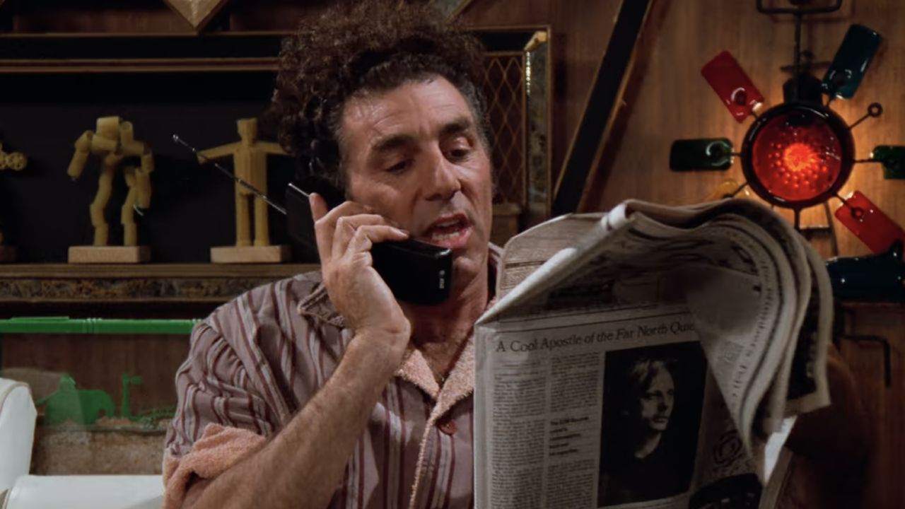 <p>                     When Kramer learns his phone number is just one digit off from Moviefone — a now defunct call-in service for looking up movie theater showtimes — he decides to accept the responsibility. Of course, it eventually gets him in hot water with the real Mr. Moviefone (Russ Leatherman), who threatens to break down his door for stealing his business.                   </p>